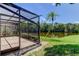Screened in patio with view of lush backyard with view of a pond at 50 Ingrid Pl # 50, Oldsmar, FL 34677
