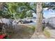 Backyard featuring a mature shade tree and showing a pile of debris on top of a blue tarp at 5109 N 30Th St, Tampa, FL 33610