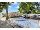 Backyard featuring a mature shade tree and showing a pile of debris on top of a blue tarp at 5109 N 30Th St, Tampa, FL 33610