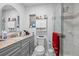 Bathroom featuring a glass shower, granite vanity and tiled walls and floors at 5109 N 30Th St, Tampa, FL 33610