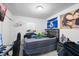 Bedroom with a large bed, gaming setup, posters, window, and fan at 5109 N 30Th St, Tampa, FL 33610