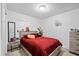 Bright bedroom featuring a cozy bed, side tables, and closet with a window view at 5109 N 30Th St, Tampa, FL 33610