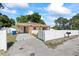 Single-story home with a white fence and a large driveway at 5109 N 30Th St, Tampa, FL 33610