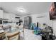 Bright kitchen area featuring white cabinets, stainless steel appliances and a glass dining table set at 5109 N 30Th St, Tampa, FL 33610