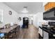 Bright kitchen with wooden floors, dining table, black appliances and ample storage at 5109 N 30Th St, Tampa, FL 33610
