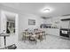 Bright kitchen area featuring white cabinets, stainless steel appliances and a glass dining table set at 5109 N 30Th St, Tampa, FL 33610