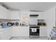 Modern kitchen with white cabinets, stainless steel appliances, and marble-like floors at 5109 N 30Th St, Tampa, FL 33610