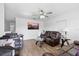 Comfortable living room with leather furniture, ceiling fan, and natural light at 5109 N 30Th St, Tampa, FL 33610