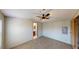 Spacious bedroom with a ceiling fan, carpeted floors, and access to a bathroom at 5824 Coventry Dr, Tampa, FL 33615
