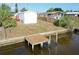 Exterior view of the waterfront property with a private wooden dock extending into the canal at 5824 Coventry Dr, Tampa, FL 33615