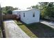 An exterior view of the home shows the driveway, front yard, and entrance at 5824 Coventry Dr, Tampa, FL 33615