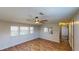 Bright living room with wood-look flooring, a ceiling fan, and plenty of natural light from the windows at 5824 Coventry Dr, Tampa, FL 33615