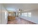 Open living area with wood-look floors, a ceiling fan, and a view into the kitchen area at 5824 Coventry Dr, Tampa, FL 33615