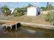A view of the house, a newly installed private dock, and a canal at 5824 Coventry Dr, Tampa, FL 33615