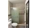 Bathroom with tiled shower featuring sliding glass doors, tiled walls, and white toilet and vanity at 5860 43Rd N Ter # 1518, Kenneth City, FL 33709