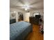 Bright bedroom with hardwood flooring, dresser, and ample closet space at 5860 43Rd N Ter # 1518, Kenneth City, FL 33709