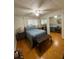 Cozy bedroom features hardwood floors, ceiling fan, and mirrored closet at 5860 43Rd N Ter # 1518, Kenneth City, FL 33709
