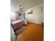 Bedroom featuring a cozy rug, hardwood floors, and natural light at 5860 43Rd N Ter # 1518, Kenneth City, FL 33709