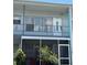 Two-story condo showcasing a screened-in lanai on the ground floor and a second-story balcony at 5860 43Rd N Ter # 1518, Kenneth City, FL 33709