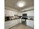 Well-lit kitchen featuring white cabinets, granite countertops, and stainless steel appliances at 5860 43Rd N Ter # 1518, Kenneth City, FL 33709