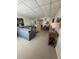 A living room and dining room area with tile flooring, gray couch, and decorative lamps at 5860 43Rd N Ter # 1518, Kenneth City, FL 33709
