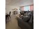 Open living area features a comfortable gray sectional couch, tile flooring and lots of decor at 5860 43Rd N Ter # 1518, Kenneth City, FL 33709