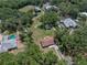 A high angle view of the property showing the arrangement of buildings amid mature trees and lawns at 5926 Frontier Dr, Zephyrhills, FL 33540