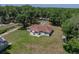 Aerial shot of a quaint home on a lot surrounded by mature trees and expansive lawns at 5926 Frontier Dr, Zephyrhills, FL 33540