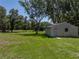 Wide view of backyard with additional structures in the background at 5926 Frontier Dr, Zephyrhills, FL 33540