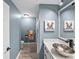 Bathroom vanity with a bowl sink, adjacent to a shower with colorful shower curtain at 5926 Frontier Dr, Zephyrhills, FL 33540