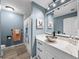 Bathroom featuring a modern vanity with a bowl sink and colorful wall art at 5926 Frontier Dr, Zephyrhills, FL 33540