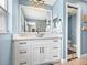 Bright bathroom featuring a white vanity with vessel sink and large mirror at 5926 Frontier Dr, Zephyrhills, FL 33540