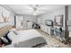 Bright bedroom features a ceiling fan, wood-look floors, and comfortable furnishings at 5926 Frontier Dr, Zephyrhills, FL 33540