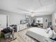 Bright bedroom features a ceiling fan, wood-look floors, and comfortable furnishings at 5926 Frontier Dr, Zephyrhills, FL 33540
