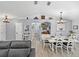 Charming dining room with white table set, stylish decor, and wood-look tile flooring at 5926 Frontier Dr, Zephyrhills, FL 33540