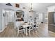 Dining area with white table, decor, and an adjacent kitchen space; stainless steel refrigerator visible at 5926 Frontier Dr, Zephyrhills, FL 33540