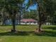 Charming single-story home with a well-maintained lawn and mature trees providing ample shade at 5926 Frontier Dr, Zephyrhills, FL 33540