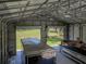 View of the spacious metal building interior with a boat, trailer, and lawn beyond the open door at 5926 Frontier Dr, Zephyrhills, FL 33540