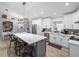 Open kitchen showcases white cabinets, stainless steel appliances, and a spacious gray island with seating at 5926 Frontier Dr, Zephyrhills, FL 33540