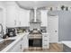 A well-equipped kitchen boasts stainless steel appliances, white cabinets, and sleek countertops at 5926 Frontier Dr, Zephyrhills, FL 33540