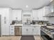 Modern kitchen with stainless steel appliances, white cabinets, granite counters, and tile backsplash at 5926 Frontier Dr, Zephyrhills, FL 33540