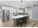 Bright kitchen features white cabinetry, stainless steel appliances, and a large gray island with a white countertop at 5926 Frontier Dr, Zephyrhills, FL 33540