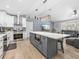 Living room with kitchen features stainless steel appliances and a large central island, connecting living spaces at 5926 Frontier Dr, Zephyrhills, FL 33540