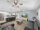 Bright living space with modern sofas, a TV, and a connected open kitchen featuring a large island at 5926 Frontier Dr, Zephyrhills, FL 33540