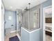 Modern glass enclosed shower with rain shower head and gray tiled walls at 5926 Frontier Dr, Zephyrhills, FL 33540