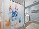 Close-up of the shower featuring a colorful shower curtain depicting a dog at 5926 Frontier Dr, Zephyrhills, FL 33540