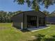 Two-bay black steel structure in backyard of property at 5926 Frontier Dr, Zephyrhills, FL 33540
