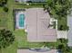 Aerial view of a home with a screened pool enclosure and well-maintained landscaping at 6009 Cedarwood Ln, Bradenton, FL 34203
