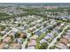 Sprawling aerial view of a neighborhood with mature trees, lakes, and well-maintained homes at 6009 Cedarwood Ln, Bradenton, FL 34203