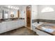 Bathroom featuring double sinks, granite countertops, and a separate shower and tub at 6009 Cedarwood Ln, Bradenton, FL 34203
